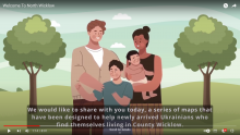 Still of video with image of man, woman holding baby, and young boy, standing in park with trees behind them and words North Wicklow video.
